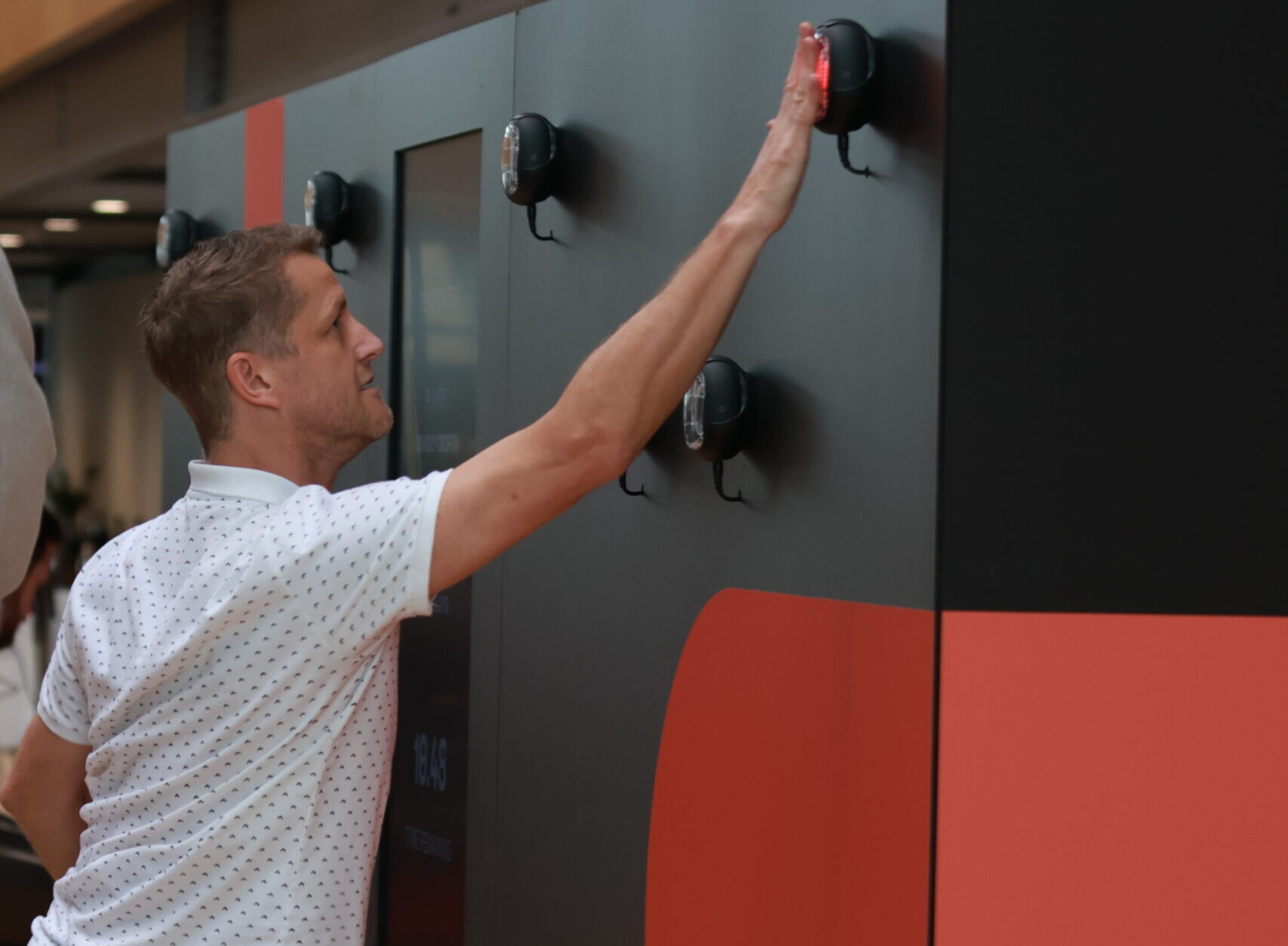 Team coordinating under pressure during reaction light game corporate team building event